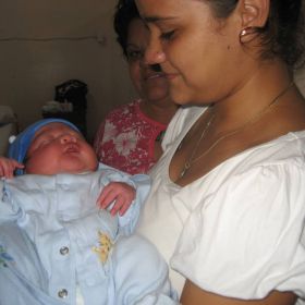 Holding a newborn at Western Regional Hospital, Bellmopan, Cayo District, Belize – Best Places In The World To Retire – International Living